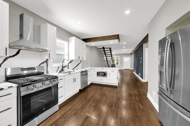 5414 W Haddon Ave, Chicago, IL 60651 - kitchen with stainless steel appliances, wall chimney range hood, plenty of natural light, a peninsula, and recessed lighting