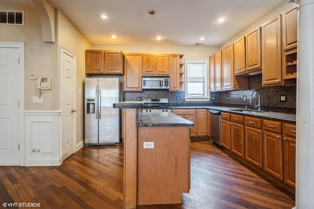 7018 S Paxton Ave Unit 3N, Chicago, IL 60649 - kitchen with stainless steel appliances, a center island, open shelves, dark wood-type flooring, and a wainscoted wall