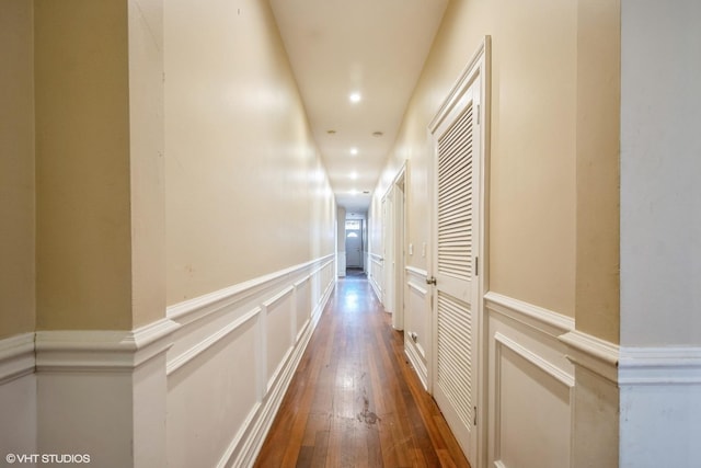 7018 S Paxton Ave Unit 3N, Chicago, IL 60649 - hallway with wood-type flooring, a wainscoted wall, recessed lighting, and a decorative wall