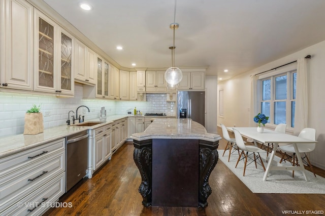 1302 N Bosworth Ave Unit 1, Chicago, IL 60642 - kitchen with appliances with stainless steel finishes, light stone countertops, dark wood finished floors, a kitchen island, and backsplash