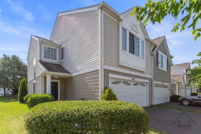 1691 Spaulding Rd, Bartlett, IL 60103 - view of side of property with an attached garage and asphalt driveway