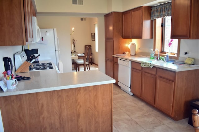 13058 Laurel Glen Ct Unit 203, Palos Heights, IL 60463 - kitchen featuring white appliances, brown cabinets, light countertops, light tile patterned flooring, and a peninsula