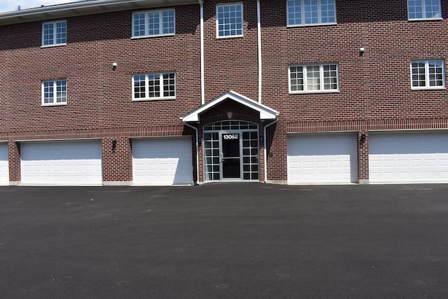 13058 Laurel Glen Ct Unit 203, Palos Heights, IL 60463 - view of building exterior featuring a garage and driveway