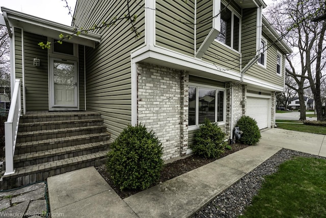 101 Croftwood Ct, Rolling Meadows, IL 60008 - view of home's exterior with an attached garage, concrete driveway, and brick siding