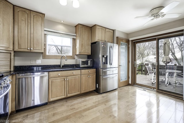 101 Croftwood Ct, Rolling Meadows, IL 60008 - kitchen with stainless steel appliances, light wood finished floors, dark stone counters, and ceiling fan