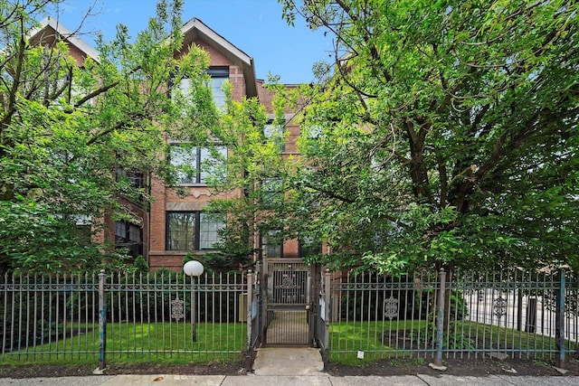 1363 E 64th St Unit 1, Chicago, IL 60637 - view of property hidden behind natural elements featuring a fenced front yard and a gate