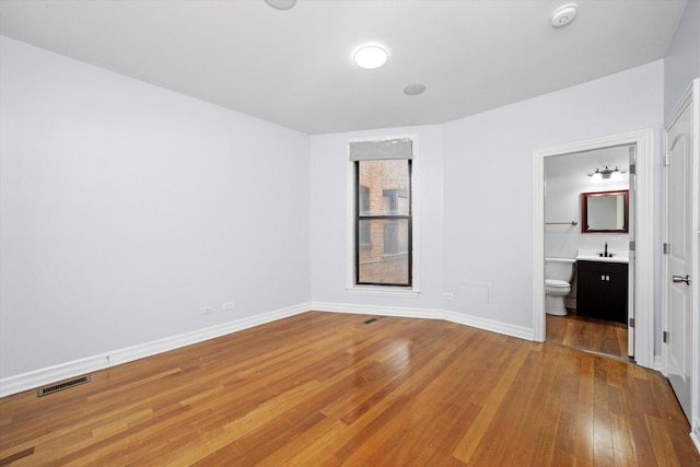 1363 E 64th St Unit 1, Chicago, IL 60637 - unfurnished bedroom with hardwood / wood-style floors and ensuite bath