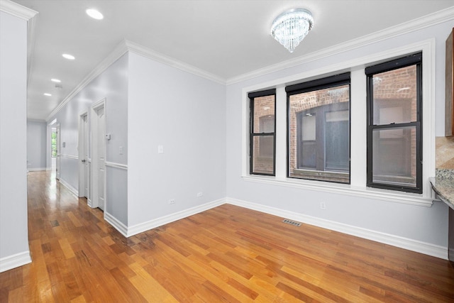 1363 E 64th St Unit 1, Chicago, IL 60637 - unfurnished room with light wood-style flooring, recessed lighting, crown molding, and a chandelier