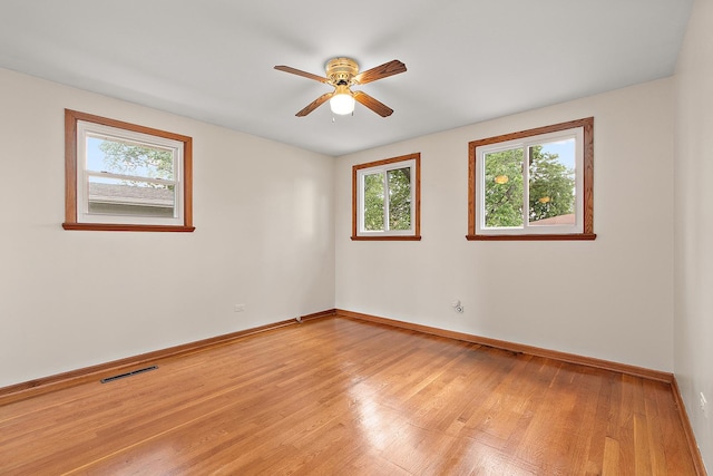 5754 150th St, Oak Forest, IL 60452 - unfurnished room featuring healthy amount of natural light, light wood-style floors, and a ceiling fan