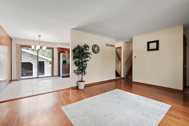 5754 150th St, Oak Forest, IL 60452 - unfurnished room featuring a chandelier, light wood-type flooring, and stairway