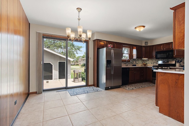 5754 150th St, Oak Forest, IL 60452 - kitchen featuring black appliances, a chandelier, light countertops, backsplash, and light tile patterned flooring