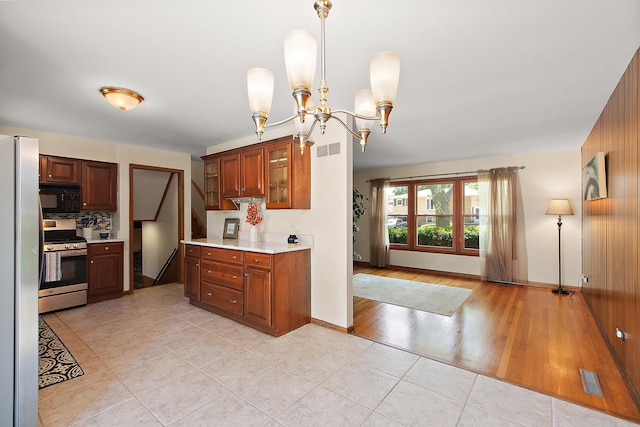 5754 150th St, Oak Forest, IL 60452 - kitchen featuring appliances with stainless steel finishes, light countertops, light tile patterned floors, glass insert cabinets, and decorative backsplash