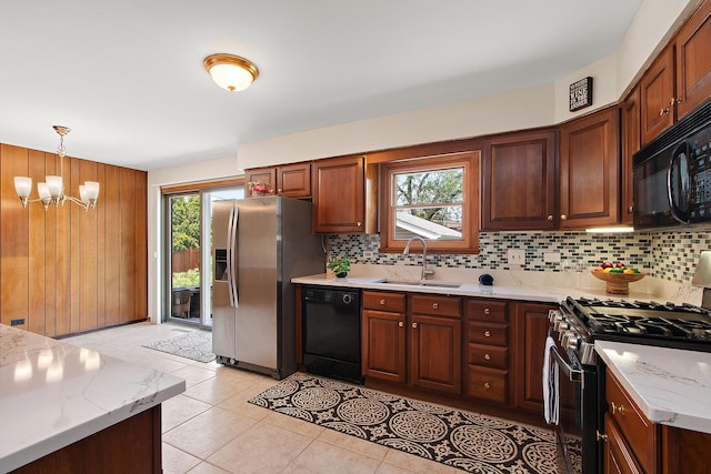 5754 150th St, Oak Forest, IL 60452 - kitchen featuring black appliances, decorative backsplash, a chandelier, hanging light fixtures, and wooden walls