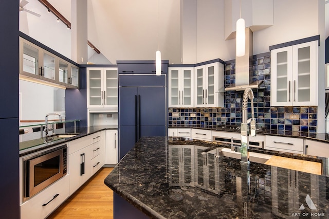 113 Oak Ridge Dr E, Burr Ridge, IL 60527 - kitchen featuring built in appliances, a towering ceiling, backsplash, light wood-style floors, and decorative light fixtures