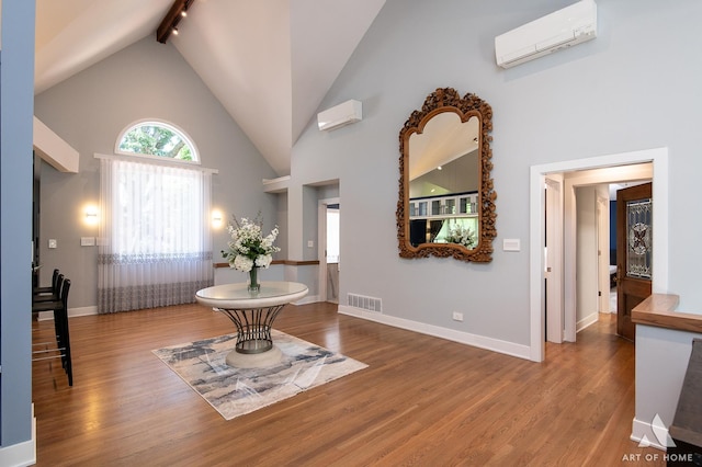 113 Oak Ridge Dr E, Burr Ridge, IL 60527 - entrance foyer featuring an AC wall unit, high vaulted ceiling, wood finished floors, and beamed ceiling