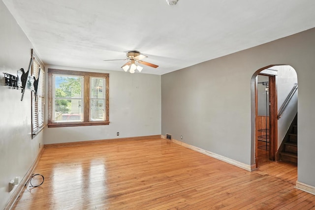 13425 S S Ave M, Chicago, IL 60633 - spare room with arched walkways, a ceiling fan, wood-type flooring, and stairs