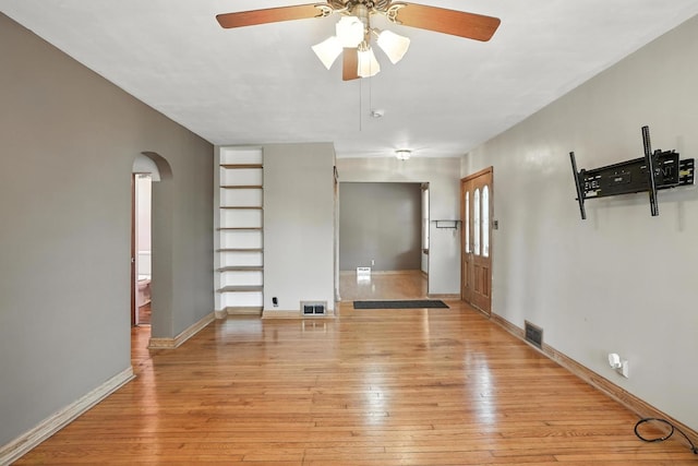 13425 S S Ave M, Chicago, IL 60633 - spare room featuring arched walkways, light wood finished floors, and ceiling fan