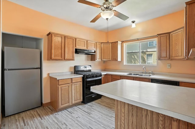 13425 S S Ave M, Chicago, IL 60633 - kitchen with freestanding refrigerator, black range with gas stovetop, under cabinet range hood, light countertops, and light wood-style floors