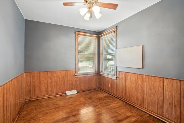 13425 S S Ave M, Chicago, IL 60633 - unfurnished room featuring wainscoting, wood finished floors, wooden walls, and a ceiling fan