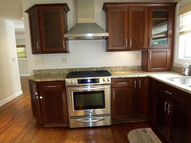 623 Willow Ln, Elk Grove Village, IL 60007 - kitchen with wall chimney range hood, stainless steel range with gas stovetop, dark wood-style flooring, and light stone counters