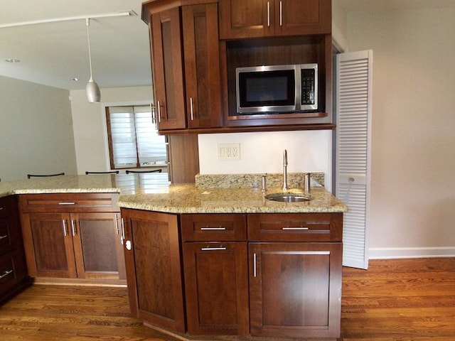 623 Willow Ln, Elk Grove Village, IL 60007 - kitchen with stainless steel microwave, dark wood-style flooring, light stone countertops, and pendant lighting