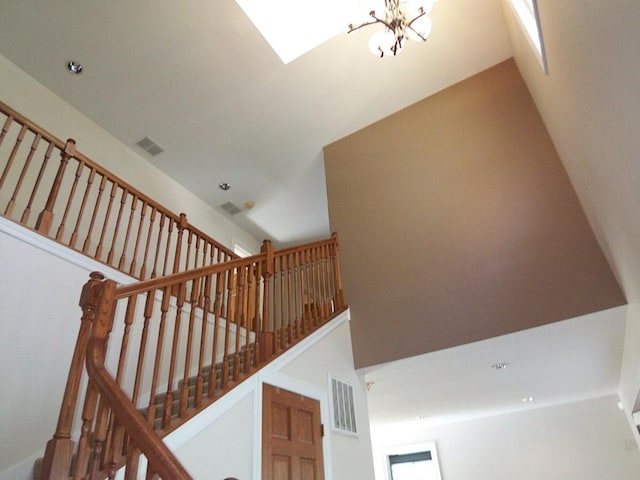 623 Willow Ln, Elk Grove Village, IL 60007 - staircase with a chandelier, a high ceiling, and recessed lighting