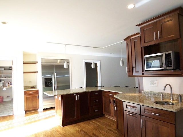 623 Willow Ln, Elk Grove Village, IL 60007 - kitchen featuring appliances with stainless steel finishes, a peninsula, light wood-type flooring, light stone countertops, and recessed lighting