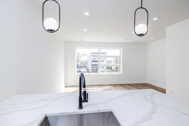 6328 S Evans Ave, Chicago, IL 60637 - kitchen view of wood finished floors, light stone counters, recessed lighting, and hanging light fixtures