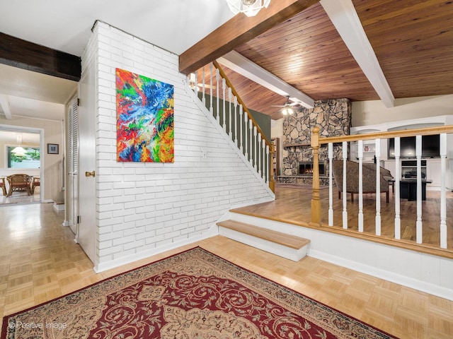 3843 Lizette Ln, Glenview, IL 60026 - stairs with beamed ceiling, a ceiling fan, and a stone fireplace