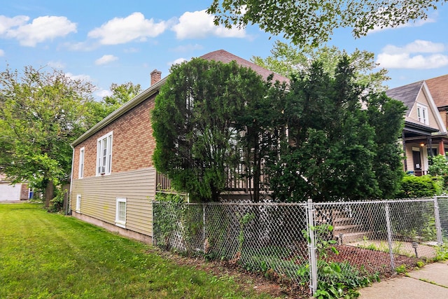7933 S Burnham Ave, Chicago, IL 60617 - view of property exterior with a chimney and brick siding