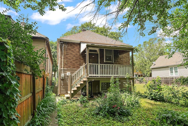 7933 S Burnham Ave, Chicago, IL 60617 - back of property featuring stairs, a fenced backyard, roof with shingles, covered porch, and brick siding