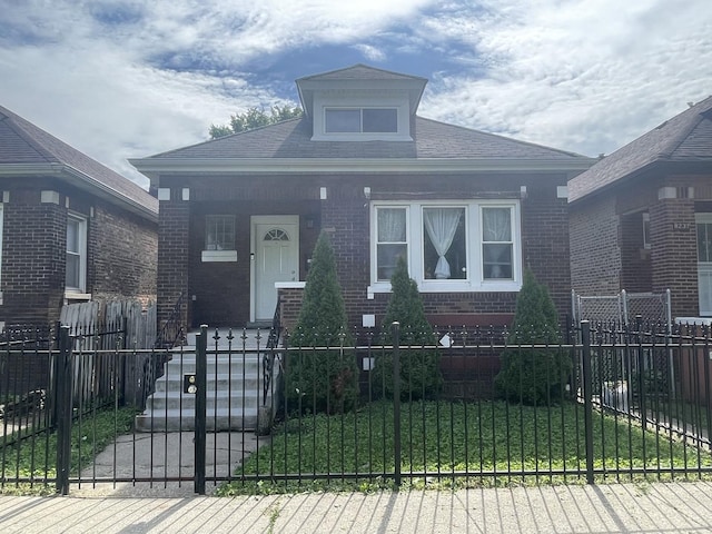 8233 S Manistee Ave, Chicago, IL 60617 - bungalow-style house featuring brick siding, a fenced front yard, a gate, and covered porch