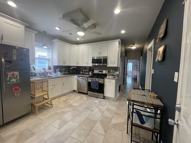 8233 S Manistee Ave, Chicago, IL 60617 - kitchen featuring appliances with stainless steel finishes, backsplash, white cabinets, a ceiling fan, and recessed lighting
