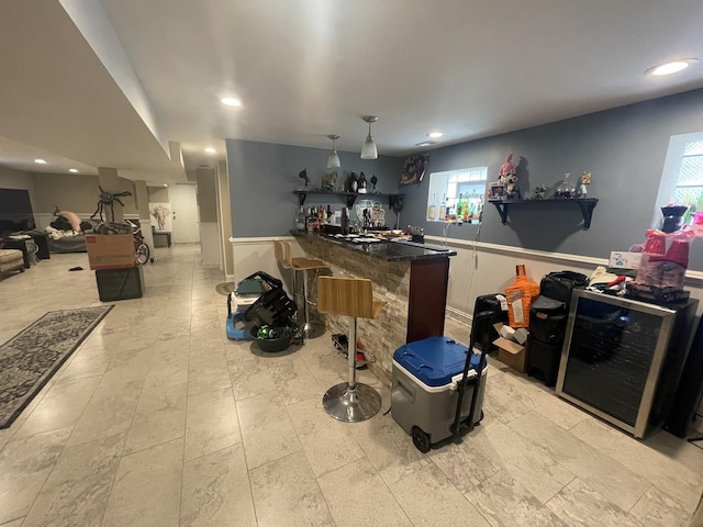 8233 S Manistee Ave, Chicago, IL 60617 - kitchen with wainscoting, recessed lighting, plenty of natural light, a kitchen breakfast bar, and beverage cooler