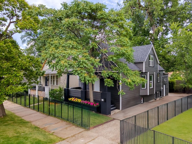 64 E 102nd Pl, Chicago, IL 60628 - view of front of home with a shingled roof and a fenced front yard