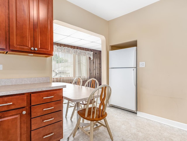 4923 W School St, Chicago, IL 60641 - kitchen with freestanding refrigerator, light countertops, and brown cabinetry