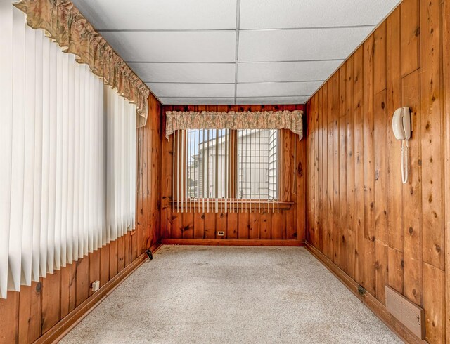 4923 W School St, Chicago, IL 60641 - carpeted empty room with baseboards and wood walls