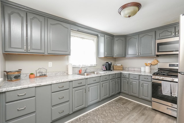 514 E Beaudoin St, Bourbonnais, IL 60914 - kitchen with gray cabinets, appliances with stainless steel finishes, and light wood-style flooring