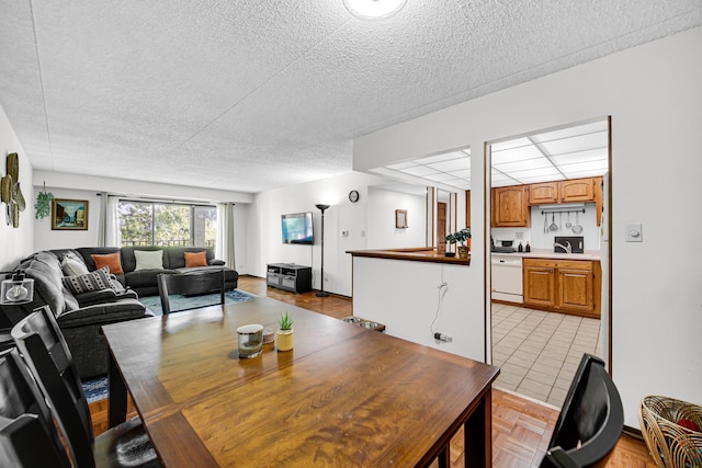475 Plum Creek Dr Unit 212, Wheeling, IL 60090 - dining area with a textured ceiling and light tile patterned floors