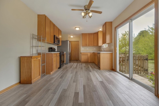 838 Valley Stream Dr, Pingree Grove, IL 60140 - kitchen with stainless steel appliances, light wood finished floors, ceiling fan, and light countertops