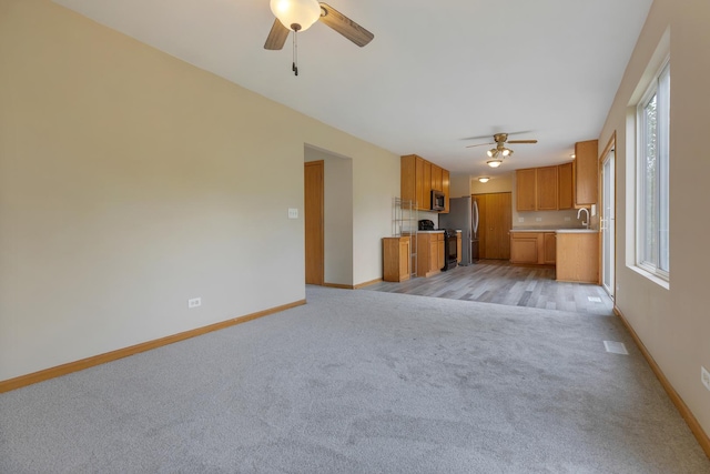 838 Valley Stream Dr, Pingree Grove, IL 60140 - unfurnished living room with ceiling fan and light colored carpet