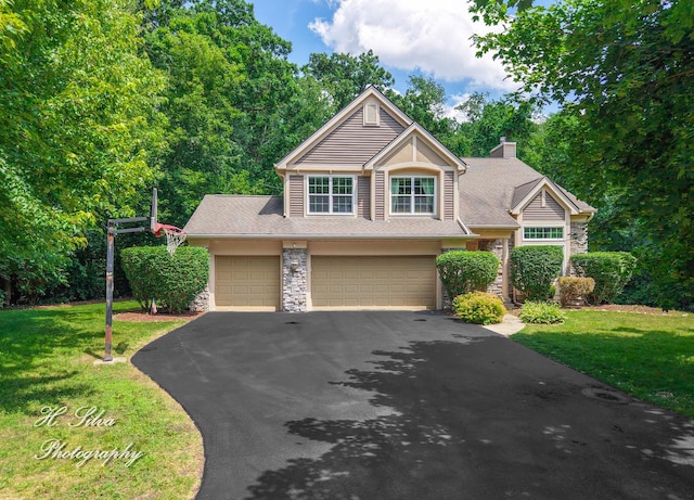 750 Seybrooke Ln, Crystal Lake, IL 60012 - view of front facade featuring asphalt driveway, a front yard, a chimney, a garage, and stone siding