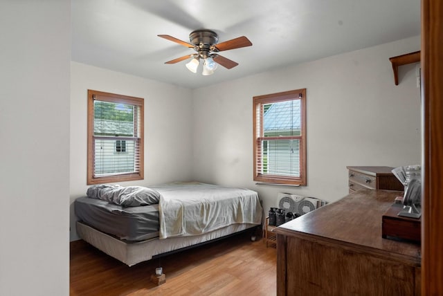 101 W Olive St, Colfax, IL 61728 - bedroom with light wood-type flooring, multiple windows, and ceiling fan