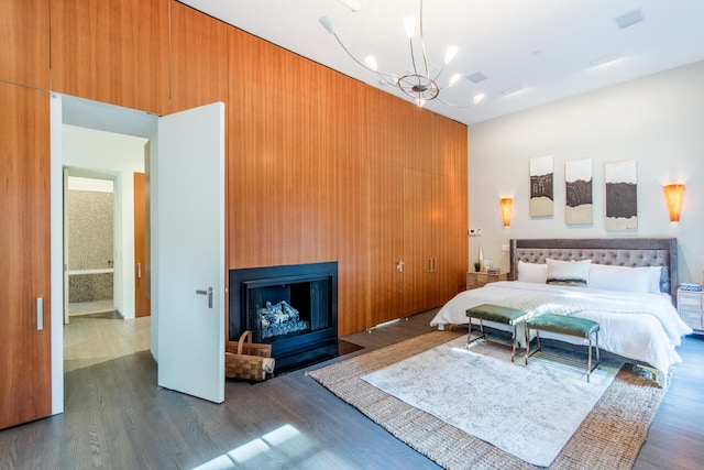 1401 N Astor St, Chicago, IL 60610 - bedroom featuring dark wood finished floors, a chandelier, a fireplace, and wooden walls
