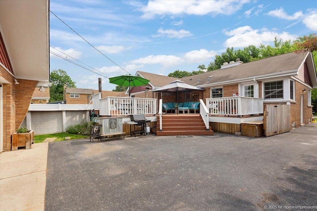 9122 S Avers Ave, Evergreen Park, IL 60805 - view of front facade featuring a deck, a patio, brick siding, and a chimney