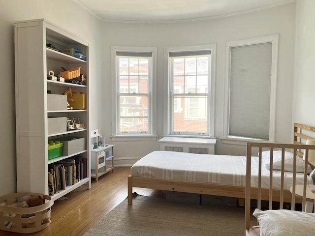 208 N Oak Park Ave Unit 3Jj, Oak Park, IL 60302 - bedroom with wood finished floors, ornamental molding, multiple windows, and radiator