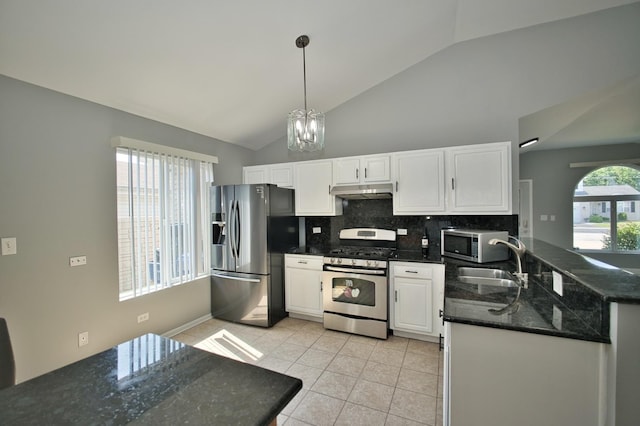 3108 141st St, Blue Island, IL 60406 - kitchen with stainless steel appliances, vaulted ceiling, decorative backsplash, white cabinets, and under cabinet range hood