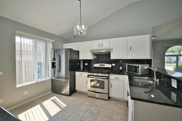 3108 141st St, Blue Island, IL 60406 - kitchen featuring appliances with stainless steel finishes, white cabinetry, backsplash, a chandelier, and dark stone counters