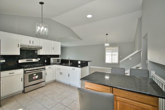 3108 141st St, Blue Island, IL 60406 - kitchen with appliances with stainless steel finishes, a chandelier, under cabinet range hood, vaulted ceiling, and light tile patterned floors