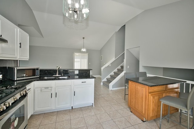 3108 141st St, Blue Island, IL 60406 - kitchen with stainless steel appliances, lofted ceiling, a peninsula, a chandelier, and white cabinets
